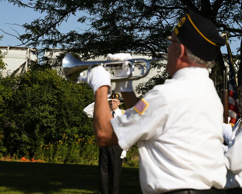 Thomas Riley (background), command caller, salutes as "Taps" is played by Denny Vaupel (foreground) during a dedication ceremony marking the completion of phase one of the DeKalb Elks Veteran’s Memorial Plaza in DeKalb Saturday, Oct. 1, 2022.