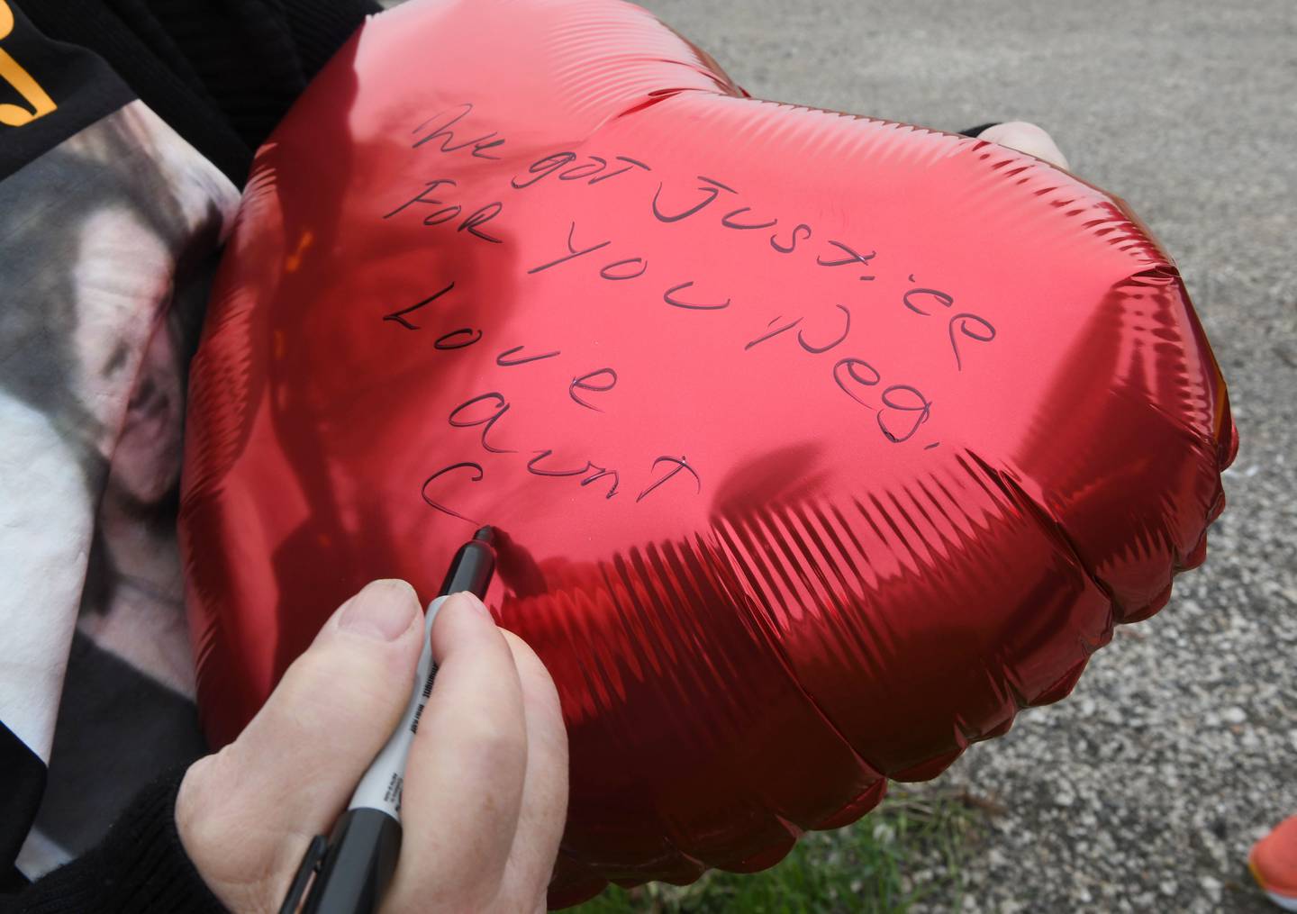 Peggy Lynn Johnson-Schroeder’s family gathered on 92nd Street in the town of Raymond, Wisconsin, where Johnson-Schroeder’s body was found in 1999, to release 10 red balloons, after Linda La Roche was sentenced Monday, May 23, 2022, in Racine County to life in prison without parole for the killing of Johnson-Schroeder in 1999. The property owner maintains the site as a memorial to Johnson-Schroeder. Her family wrote messages to Johnson-Schroeder on the balloons before releasing them.