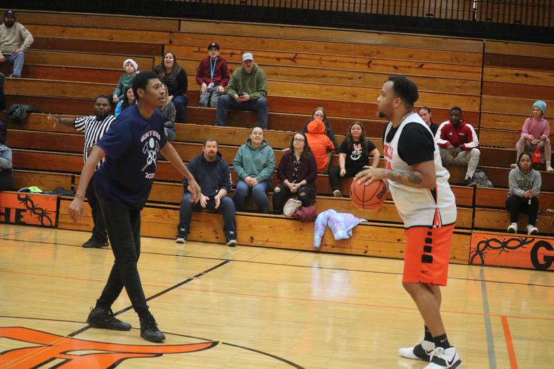 Luke Davis dribbles up the floor as Landen Gadney (left) puts pressure on him at half court Dec. 4, 2023 during the annual Guns and Hoses Basketball Game put on at Huntley Middle School in DeKalb.