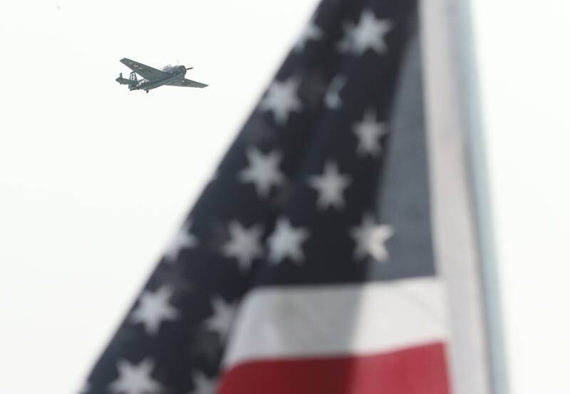 A TBM flies above an American Flag during the TBM Avenger Reunion on Friday, May 19, 2023 at the Illinois Valley Regional Airport in Peru.