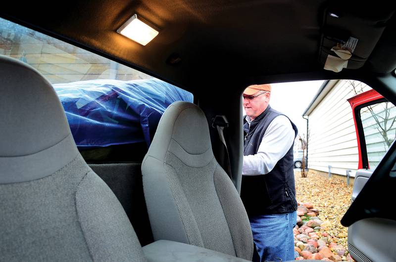 Mike McCulloch of Rochelle straps in a newly purchased chest December 15, 2012 to take it home. McCulloch was not only looking for a deal but wanted to help out the city of DIxon by making the purchase.
