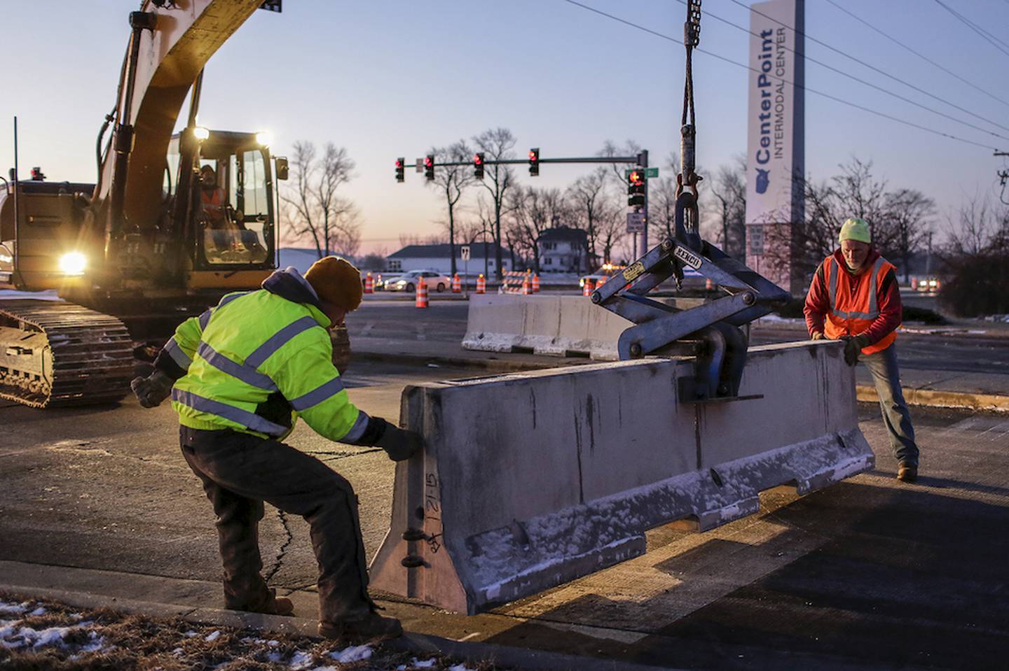 A crew works Wednesday morning to close of access to Walter Strawn Drive from state Route 53 in Elwood. The closure of the road comes as a result of a ruling by the Illinois Commerce Commission that said a railroad crossing is too dangerous to remain open.