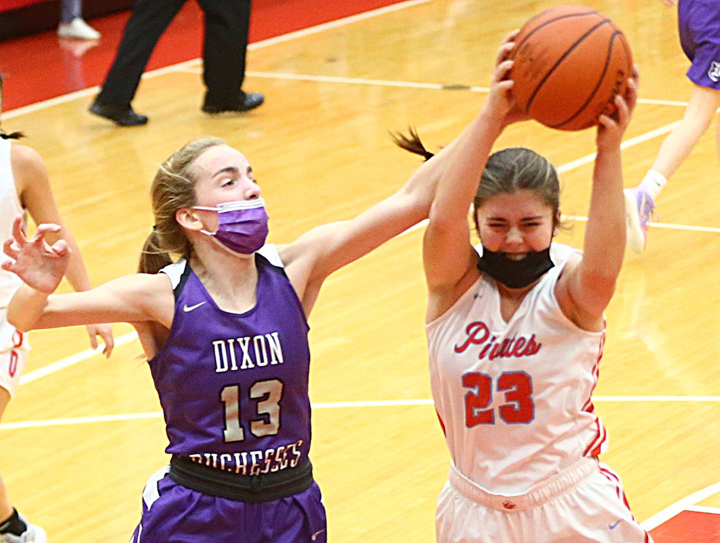 Ottawa's Brooke Waddell (23) grabs a rebound over Dixon's Kait Knipple (13) during a game on Wednesday Dec. 1, 2021 at Kingman Gym in Ottawa..