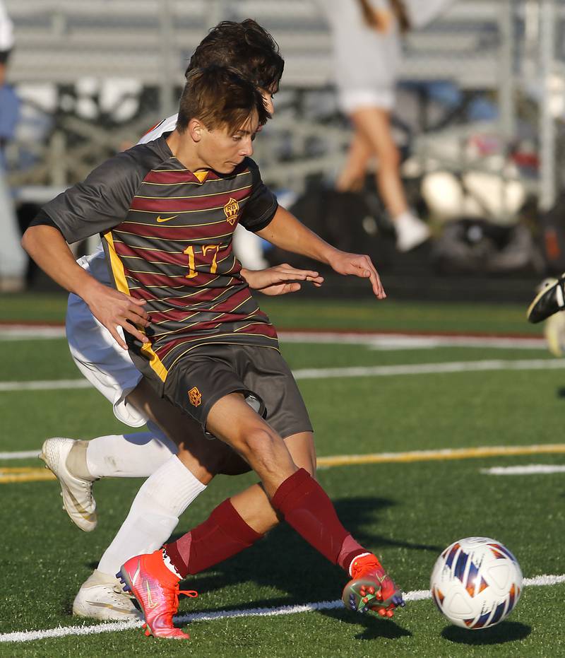 Richmond-Burton's Joseph Kyes kicks a goal as he is defended by Winnebago's Paxton Freeman during the IHSA Class 1A Richmond-Burton Regional Final soccer match Tuesday, Oct. 17, 2023, at Richmond-Burton High School in Richmond.