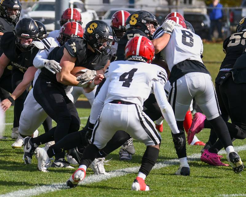 Sycamore's Burke Gautcher, center, scores a touchdown while being defended by Chicago Bulls College Prep's Khmari Cross during week one of the class 5A playoff game on Saturday Nov. 2, 2024, held at Sycamore High School.