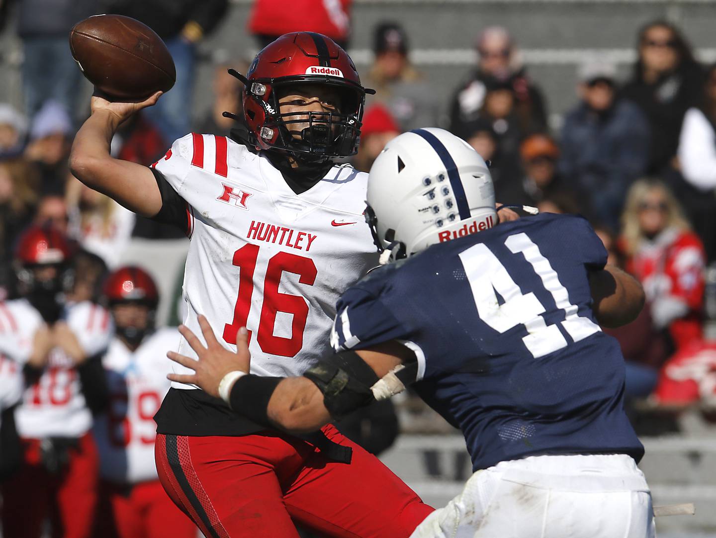 Huntley's Braylon Bower throws a pass a Cary-Grove's Ian Moran rushes during a Fox Valley Conference football game on Saturday, Oct. 7, 2023, at Cary-Grove High School.