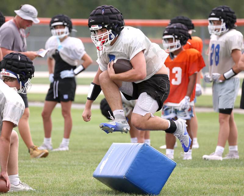 Genoa-Kingston’s Owen Zaccard jumps over a blocking pad Tuesday, Aug. 19, 2025, during practice at the school.