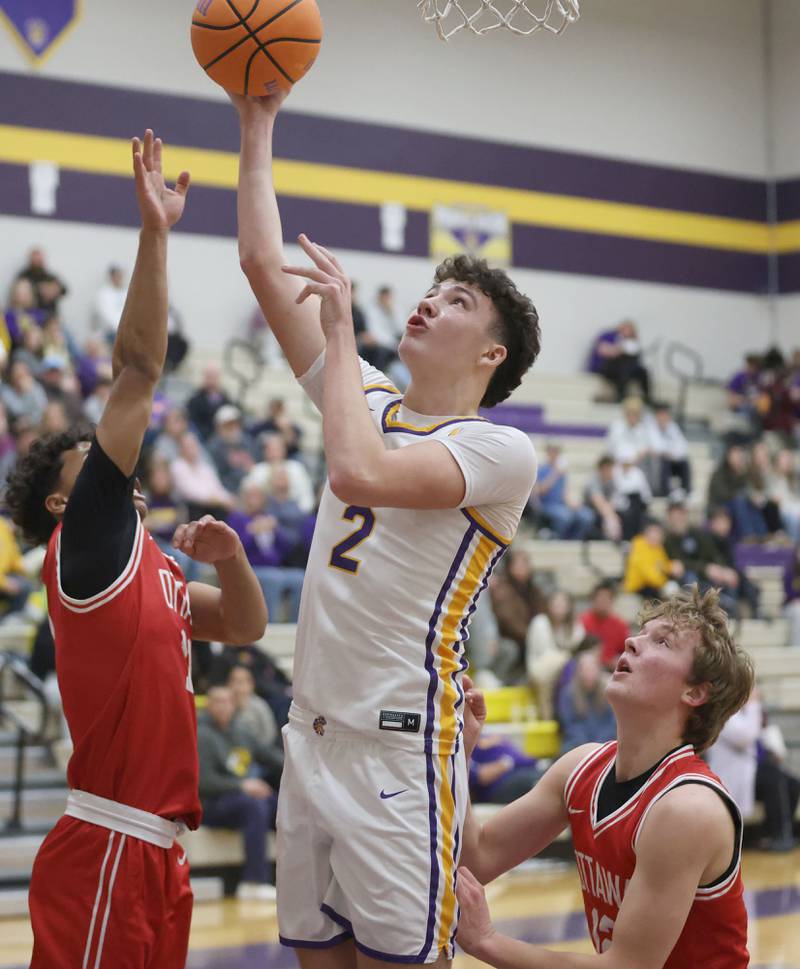 Mendota's Drew Becker slides between Ottawa defenders Hezekiah Joachim and Jack Carroll to score on Tuesday, Jan. 6, 2026 at Mendota High School.