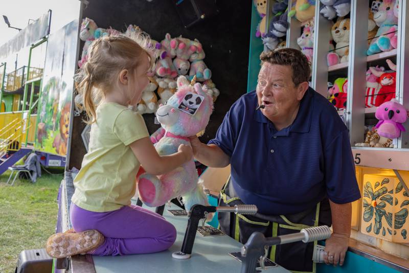 Isabella Trumper, 3, receives her stuffed animal prize for winning the water gun game at the Tri County Fair on August 30, 2025 in Mendota.