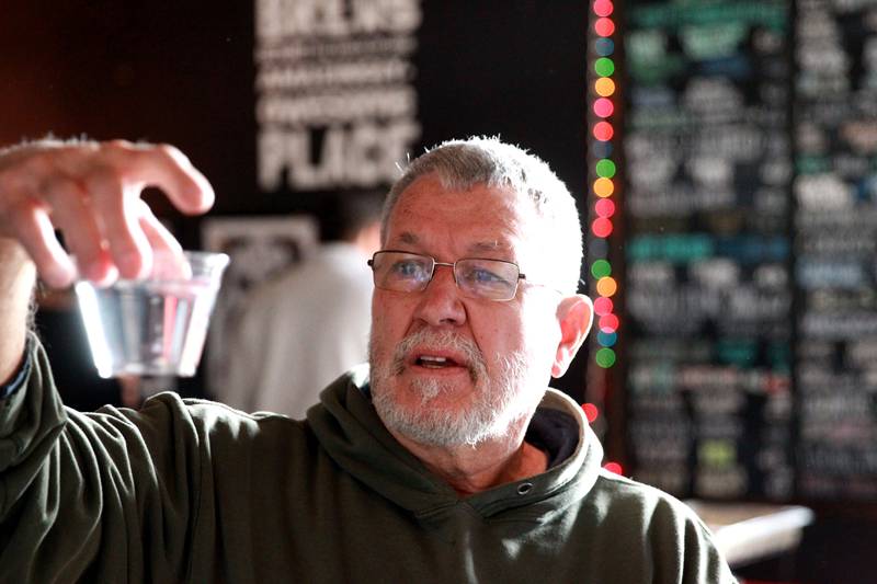Dan Young of Batavia checks the clarity of water in a blind judging on Thursday, Dec. 19, 2024 during the annual Kane County Water Association's annual water tasting contest at Global Brew in St. Charles.