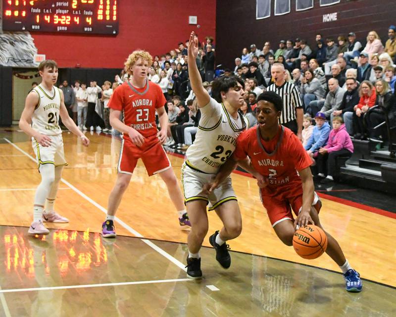 Yorkville Christian's Zach Marini (23) plays defense on Aurora Christian's James Baker (2) during the regional title game on Friday Feb. 28, 2025, held at Indian Creek High School.