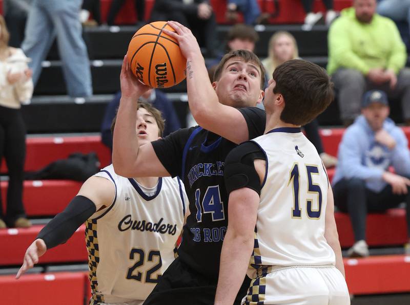Hinckley-Big Rock's Austin Roop looks to score over Marquette's Alec Novotney Tuesday, March 3, 2026, during their sectional semifinal matchup at Amboy High School.