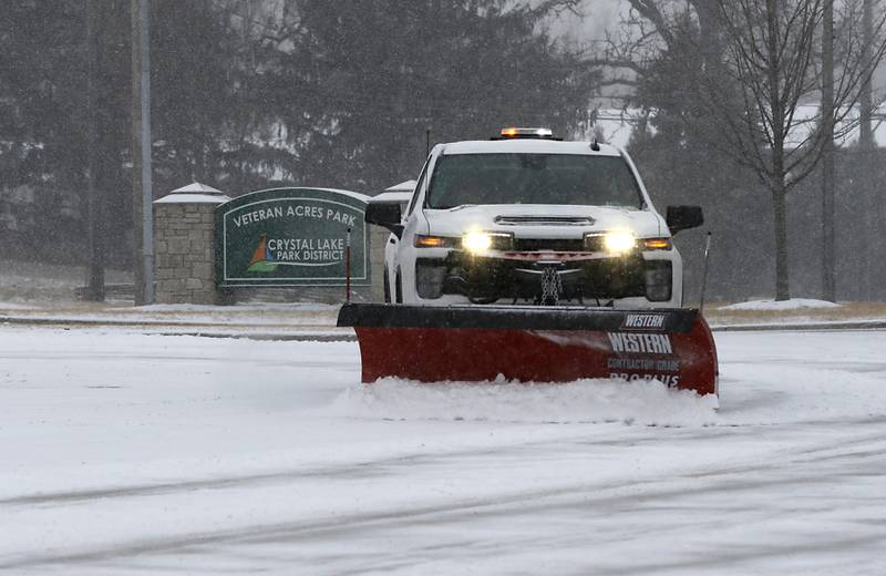 Snow is plowed from the parking lot on Veteran Acres Park on Wednesday, Feb. 12, 2025, in Crystal Lake as a winter storm starts to bring heavy snow to the McHenry County area