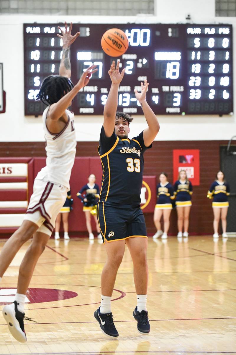Sterling's Maddux Osborn shoots under pressure from Kankakee's Lincoln Williams during the Kays' 85-50 victory over Sterling in the IHSA Class 3A Morris Regional championship on Friday, Feb. 28.