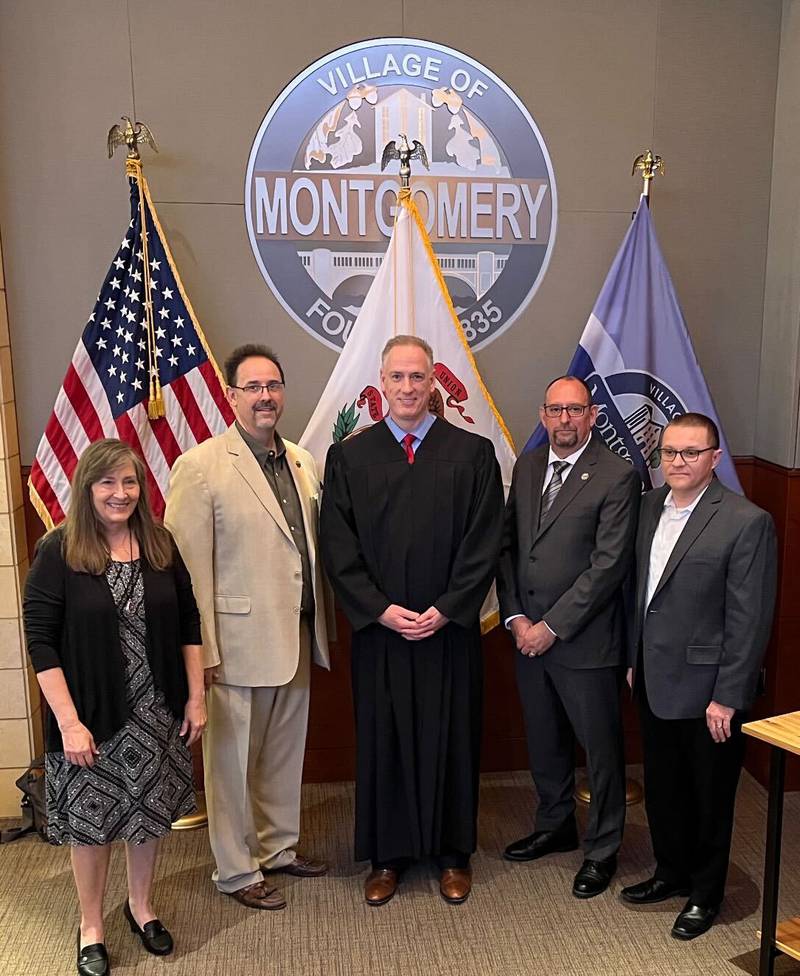 Kendall County Associate Judge John McAdams, center, swore-in, from left, Village Clerk Debbie Buchanan and Village Board members Doug Maracek, Dan Gier and Matt Bauman to new terms during a brief ceremony held during the May 8, 2023 Village Board meeting at Village Hall.