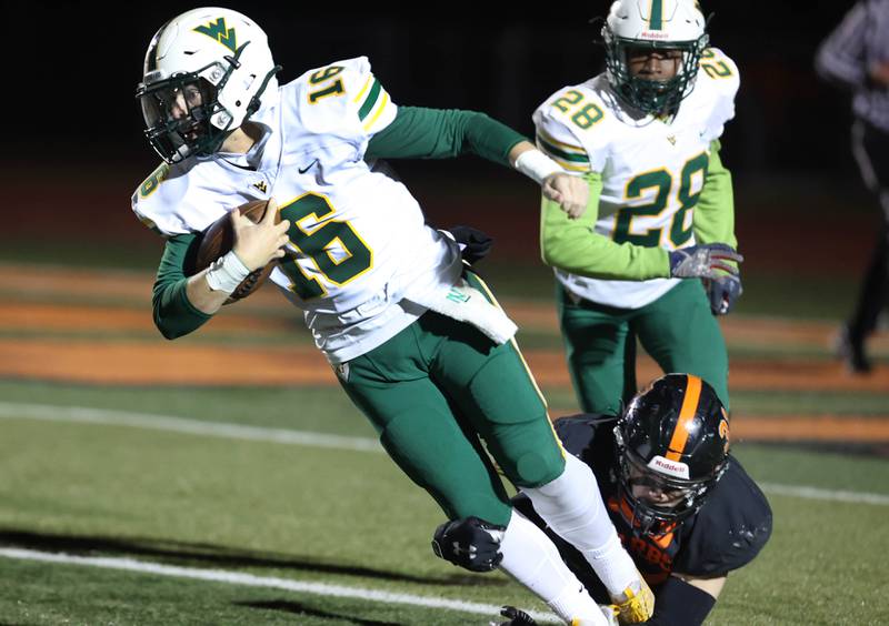 Waubonsie Valley's Luke Elsea tries to break the tackle of DeKalb's Dominic Ohlinger during their game Thursday, Oct. 20, 2022, at DeKalb High School.