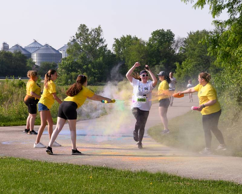 Sarah Brazier of Sycamore is all smiles as she runs through a color station on Saturday, June 7, 2025, during the CASA DeKalb County 5K Color Run held at the Sycamore Middle School.