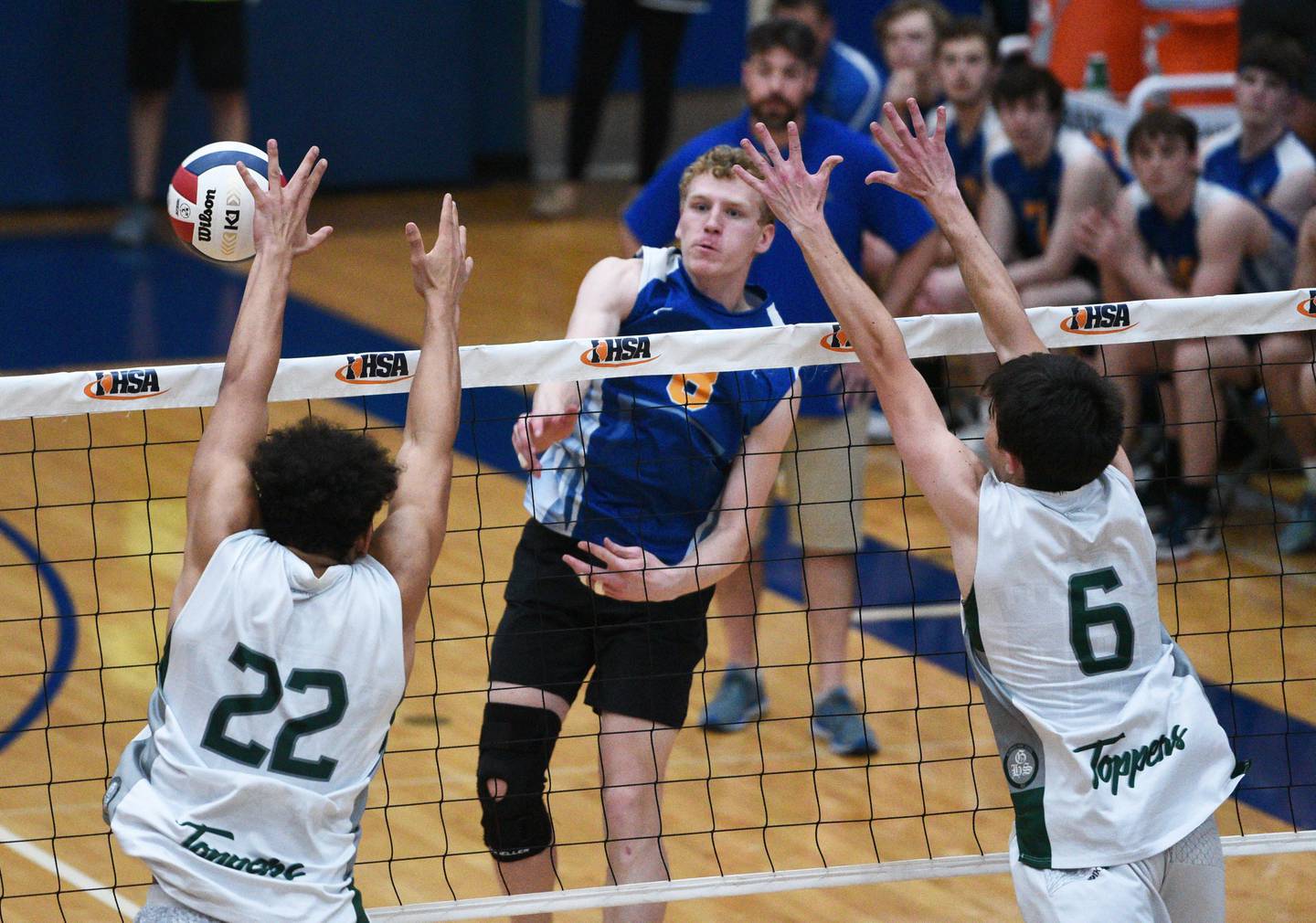 Lyons Township's Sam Levinson, center, hits past the Glenbard West defens during Saturday’s state boys volleyball championship  match in Hoffman Estates.