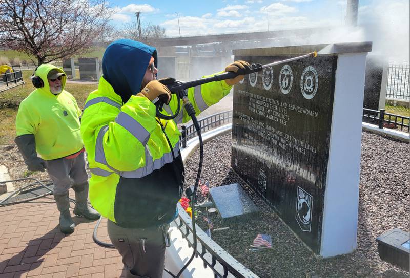 Laborers Local 393 volunteer Thomas Simon power washes the Middle East Conflicts Memorial Wall on Wednesday in Marseilles.