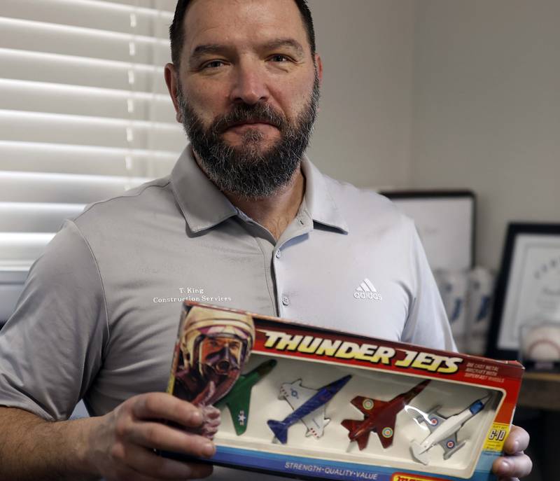 While doing some minor bathroom remodeling on his parents' longtime home Tim King discovered a Christmas present addressed to him from 1978.  King who owns TKING Construction Services, proudly displays the toy airplanes  Thursday, Jan. 9, 2025 at his Lombard home.