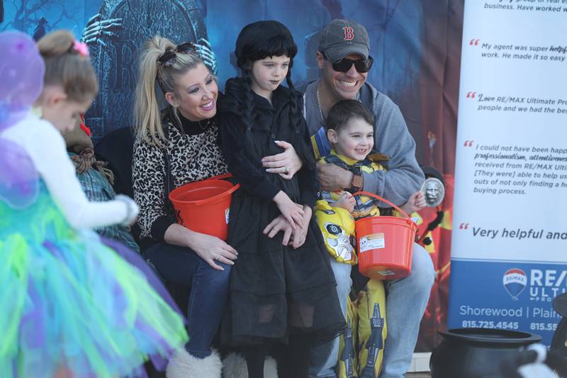 The Wineinger family gets their photo taken at the Re/Max Halloween display at the annual Halloween Spooktacular in downtown Plainfield on Saturday, Oct. 28, 2023.