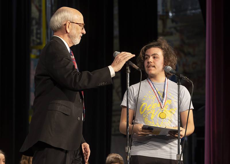 Announcer Tom Wadsworth speaks to winner Unity Christian’s Jake Bailey on Thursday, Feb. 22, 2024, at the Lee-Ogle-Whiteside regional spelling bee.