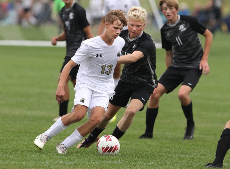 Sycamore's Aiden Sears tries to hold off Kaneland's Sam Keen during their game Wednesday, Sept. 6, 2023, at Kaneland High School in Maple Park.