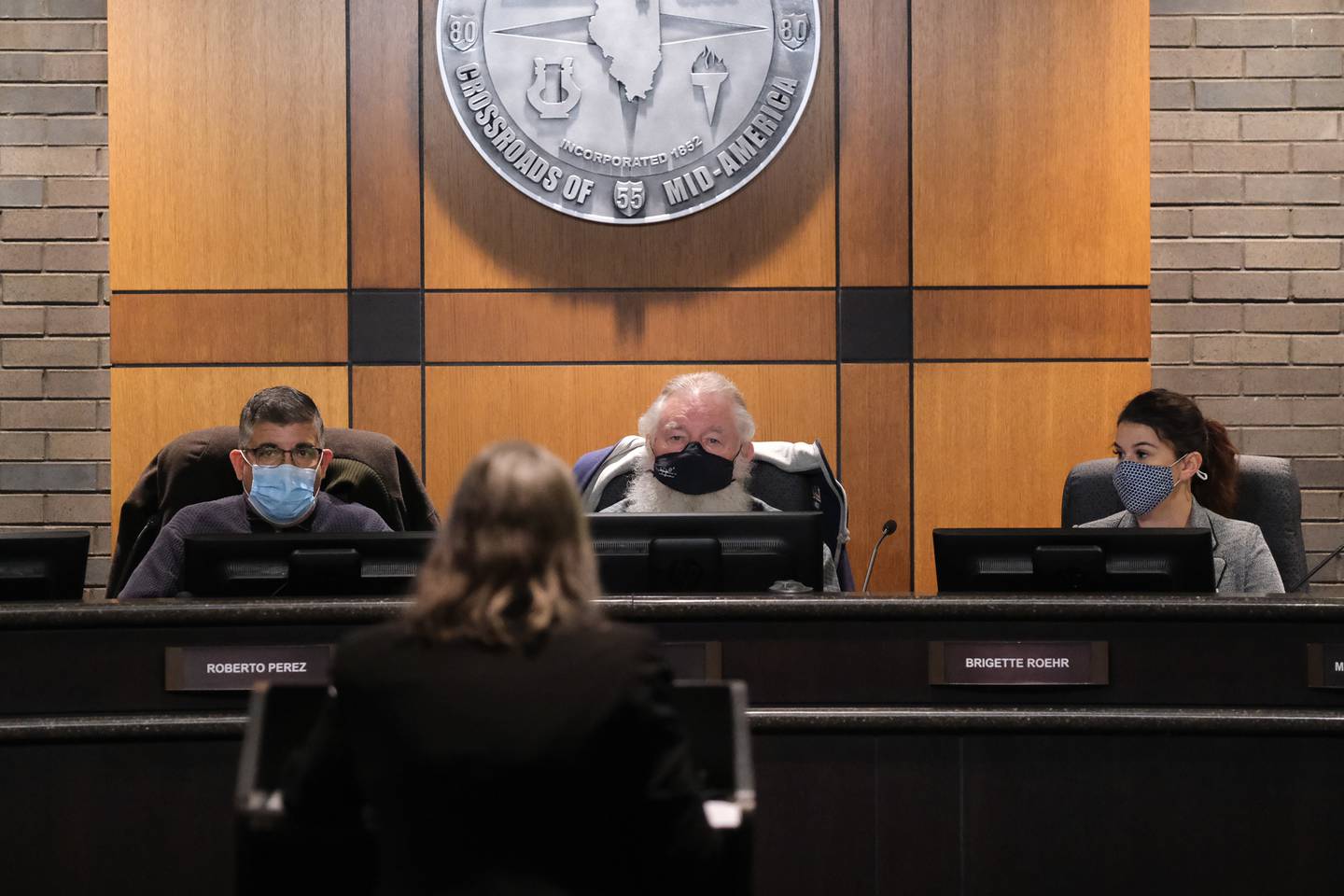 Board members Roberto Perez (left to right), John Kella and Brigette Roehr listen to Stacy Meyers, of Openlands, speak at the Joliet Plan Commission meeting regarding NorthPoint's development of the Compass Business Park. Thursday, Nov.18, 2021 in Joliet.