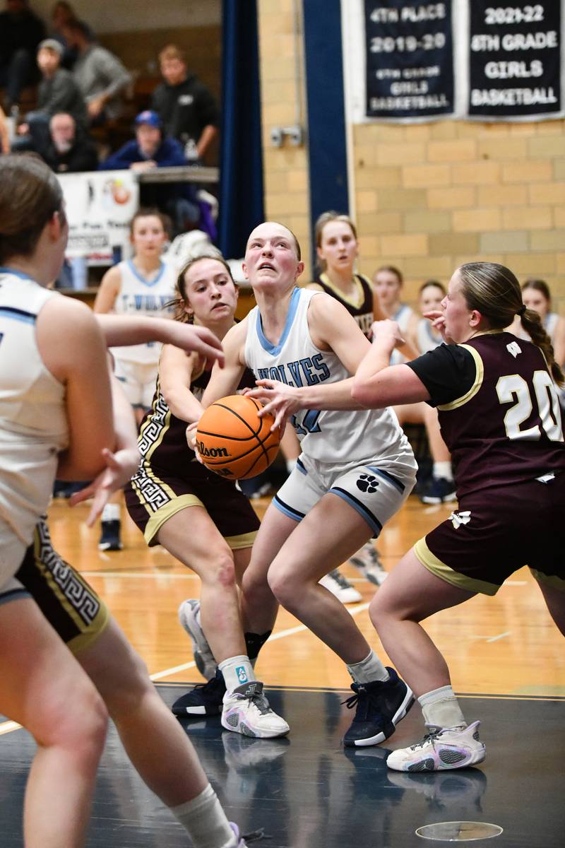 Cissna Park's Josie Neukomm looks to the basket under pressure from Watseka-Milford's Christa Holohan and Noelle Schroeder, right, on Monday, Feb. 10, 2025, during the Timberwolves' 61-40 victory over Watseka-Milford.