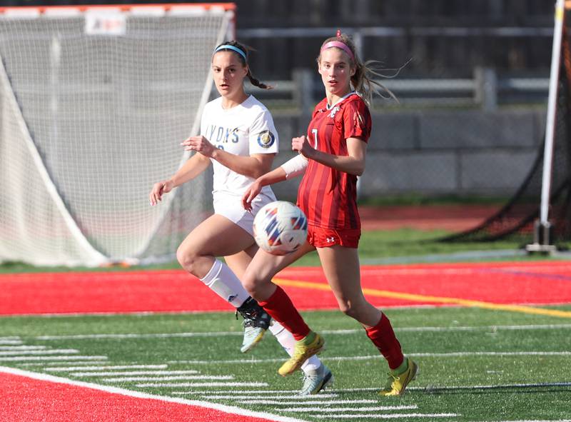 Hinsdale Central's Avery Edgewater (7) chases down the ball against Lyons Township's Caroline McKenna (10) during the girls varsity soccer match between Lyons Township and Hinsdale Central high schools in Hinsdale on Tuesday, April 18, 2023.