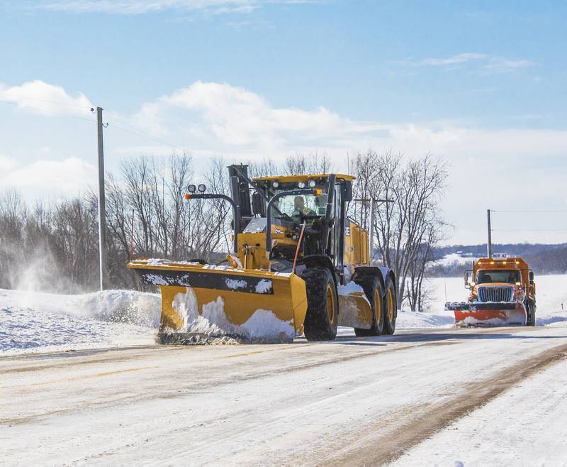 A grader and a snow plow work to clean up Garden Plain Road in rural Whiteside County Friday February 5. Crews worked to improve road conditions around the Sauk Valley Friday after winter storms covered roads with layers of snow and ice.