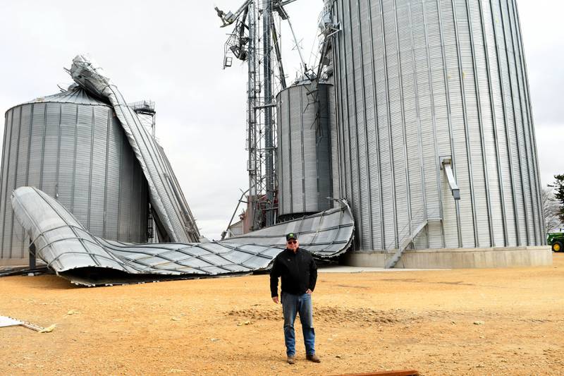 Jim Ludwig of Lanark stands by the 125-grain bins that were damaged during Friday's storm along Illinois 64 about 5 miles east of Lanark.