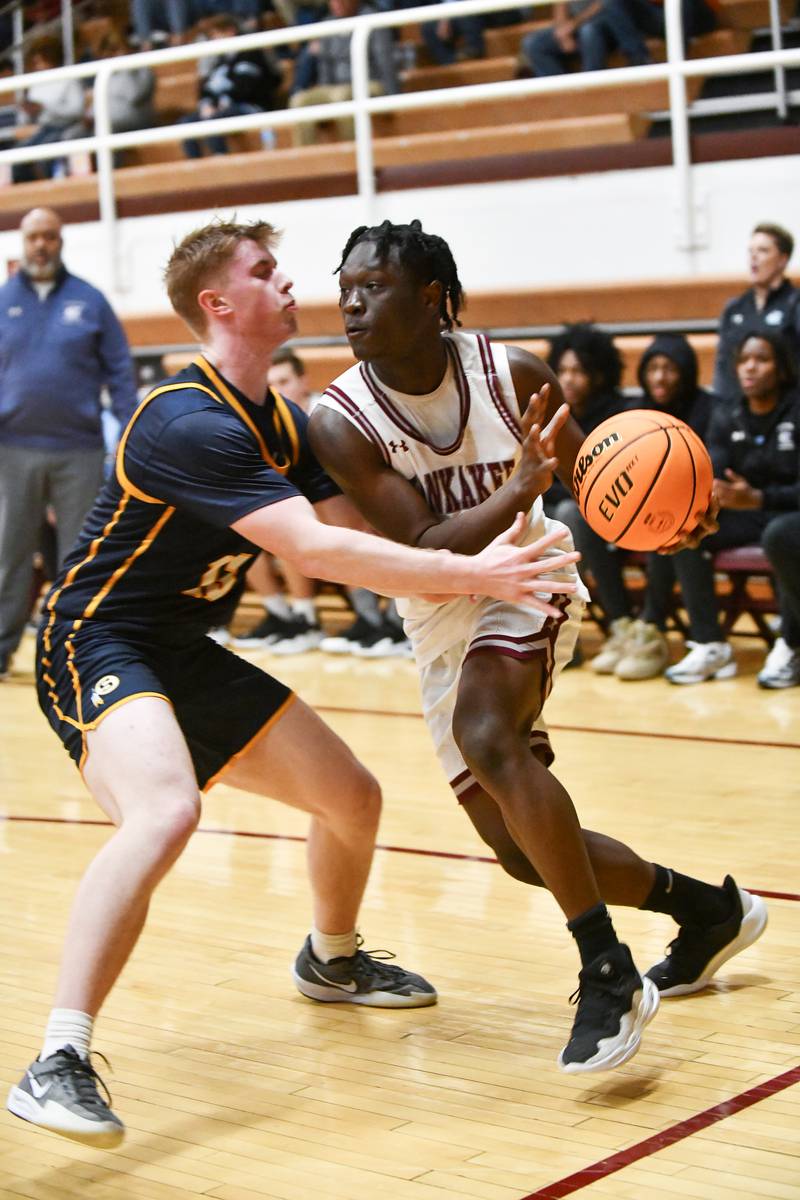 Kankakee's Jordan Davis looks to pass around Sterling's Will Ports during the Kays' 85-50 victory over Sterling in the IHSA Class 3A Morris Regional championship on Friday, Feb. 28.