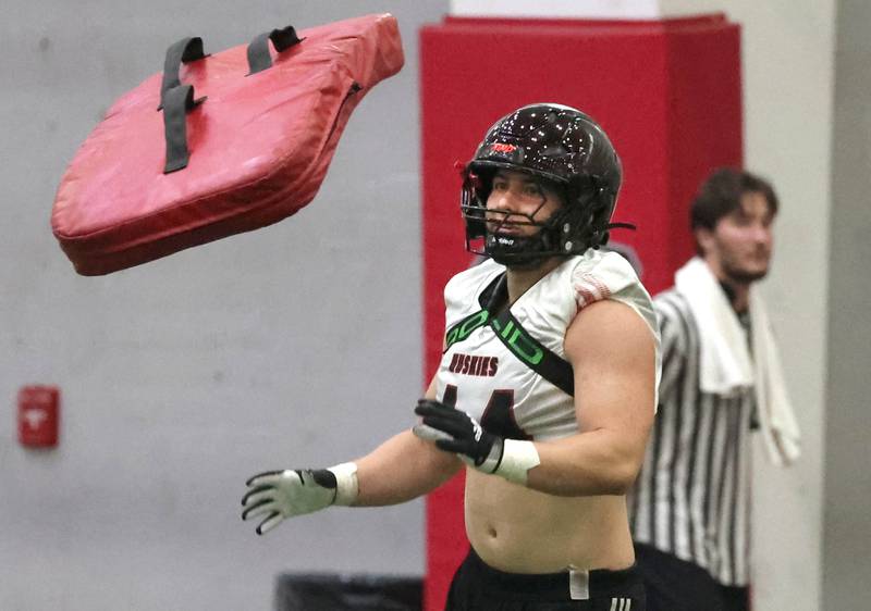 Northern Illinois University linebacker Christian Fuhrman catches a blocking pad before the start of a drill Wednesday, July 31, 2024, at practice in the Chessick Practice Center at NIU.