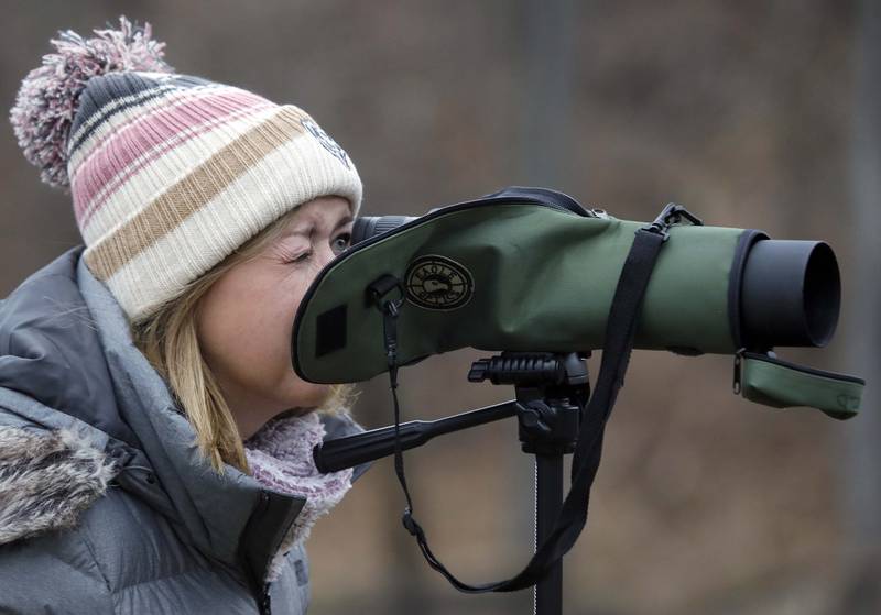 Cathy Thurston of Crystal Lake uses a spotting scope at Cornish Park during the ÒIn Search of EaglesÓ program Saturday January 21, 2023 in Algonquin. This is the second year that Thurston has attended the event.