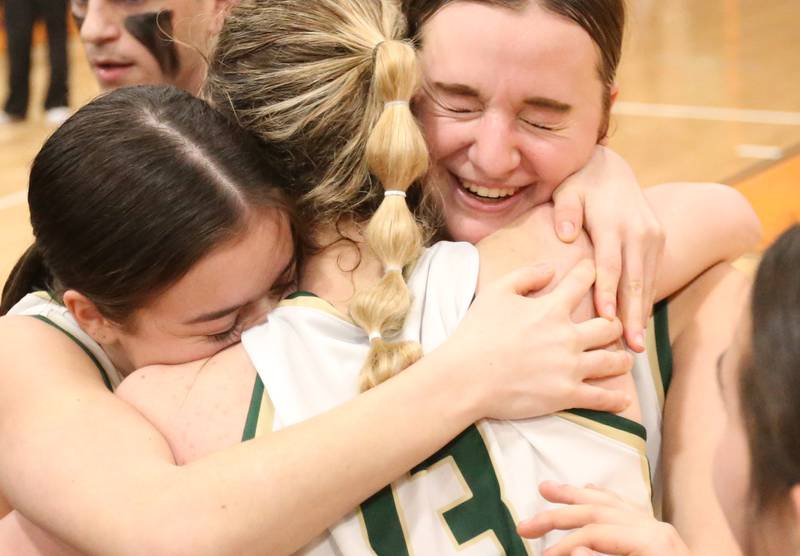 St. Bede's Bailey Engles, Ashlyn Ehm and Quinn McClain share a hug after defeating Serena in the Class 1A Sectional final game on Thursday, Feb. 22, 2024 at Gardner-South Wilmington High School.
