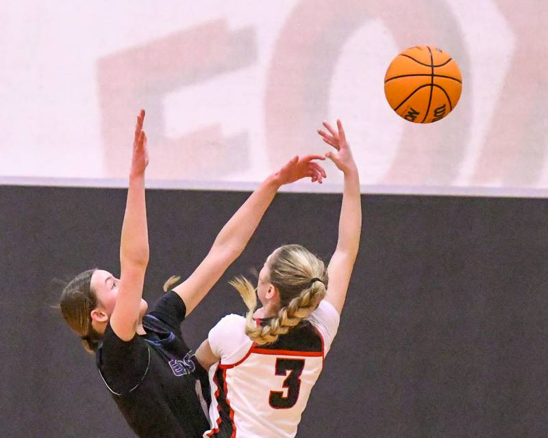 Oswego East's Aubrey Lamberti (1) blocks the shot of Yorkville's Alayna Demas (3) during the game on Thursday Dec. 18, 2025, held at Yorkville High School.
