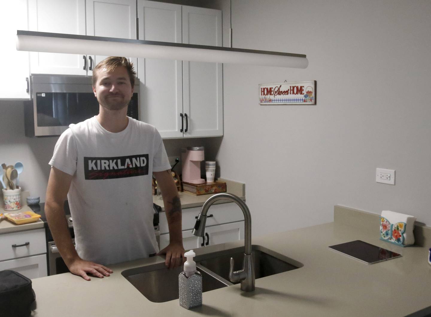 Jacob Haug in the kitchen area of his two-bedroom apartment in the Cornell Apartments near downtown Huntley on Tuesday, Sept. 5, 2023. The building was formally the home to the Cornell Brothers Milk Condensing Factory and H.D. Catty.