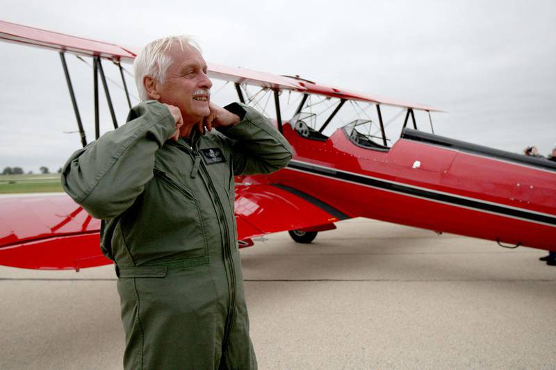 Claude Sonday, of Woodstock, suits up in preparation to fly his 1941 Stearman at the DeKalb Taylor Municipal Airport on Thursday, Sept. 11, 2014. The Stearman's original purpose was a military training plane for World War II.