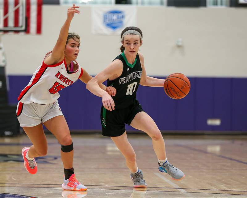 Providence's Molly Knight (10) drives past the defense of Lincoln Way Central's Gianna Amadio (15) in the WJOL Tournament Championship game. Nov 18, 2023.