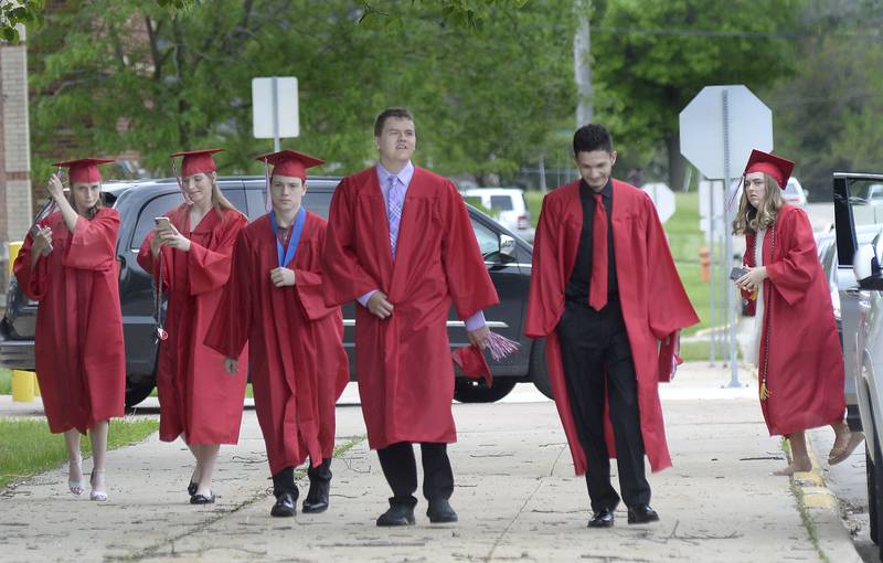 Coming all dressed and ready to go, some of the graduating Class of 2022 arrives at Streator High School on Sunday, May 22, 2022, for their graduation ceremony.