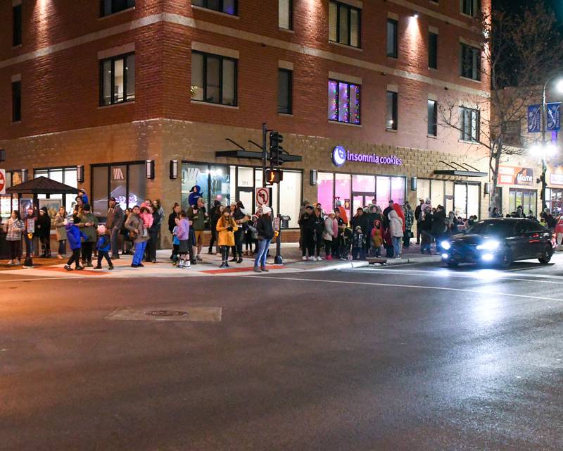 Community members line the corner of Second Street and Lincoln Highway to watch Santa pass by during the DeKalb Chamber of Commerce's annual Lights on Lincoln and Santa Comes to Town event held in downtown DeKalb on Thursday, Nov. 30, 2023.