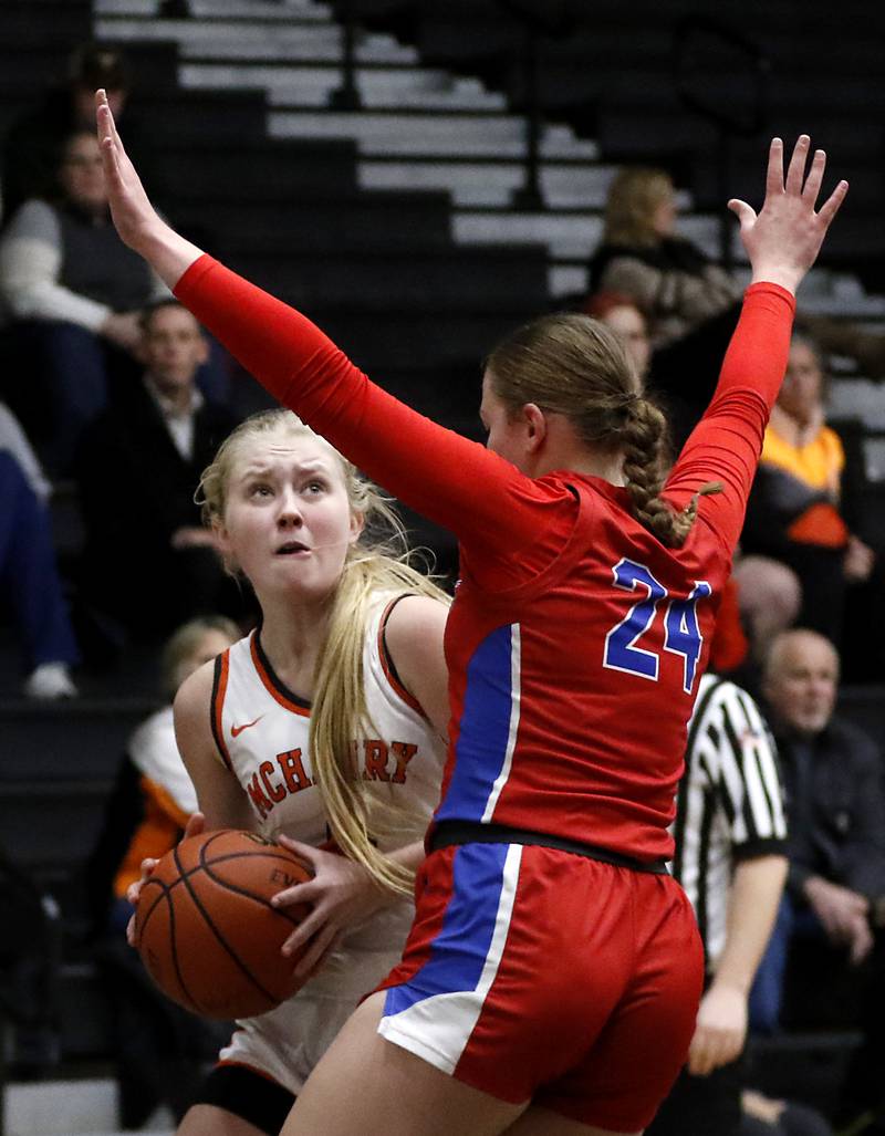 McHenry's Holly Waters looks to shoot as she is guarded by Dundee-Crown’s Mikayla Saas during a Fox Valley Conference girls basketball game on Tuesday, Dec. 12, 2023, at McHenry High School.