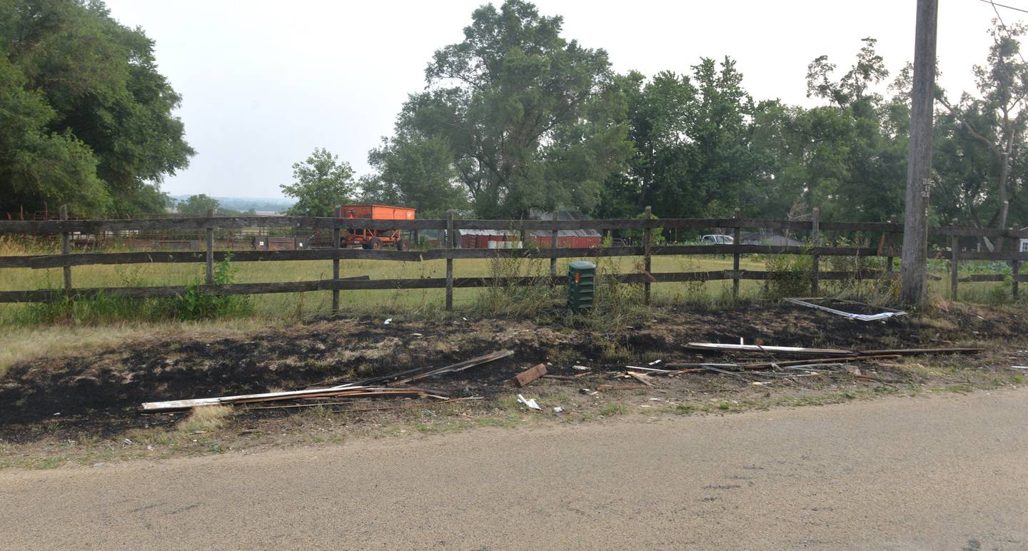 The blast traveled across East High Road burning grass along the ditch and leaving debris on the pavement.