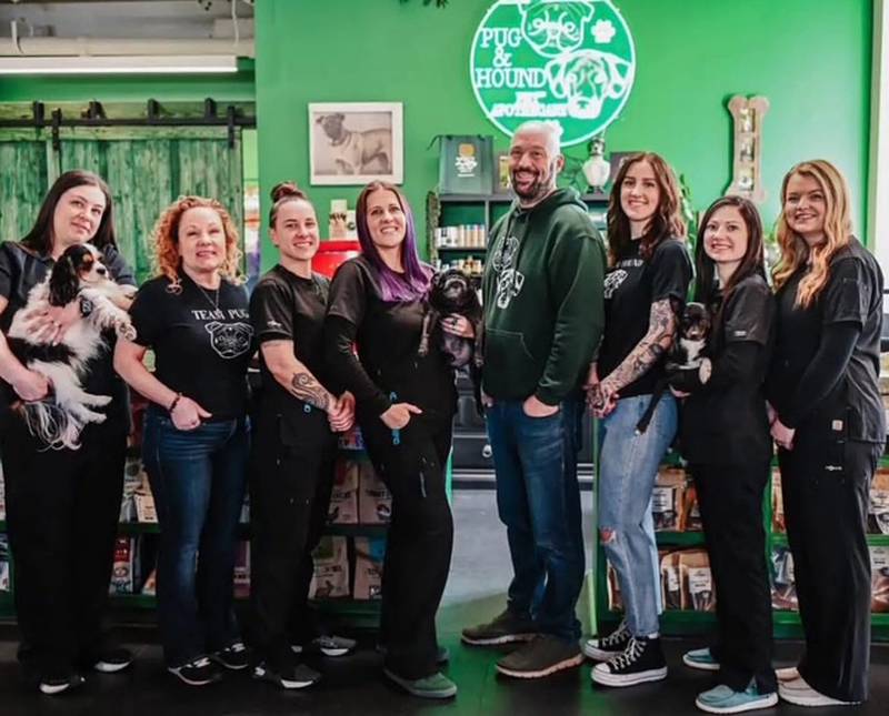Pug & Hound Apothecary in Geneva was named America's Coolest Pet Store by Pets Plus Maagazine. The Pug & Hound staff are Jessica Thiede (left) holding her dog Vivian, Carolyn Milani, Kiandra Powell, owners Krysta Fox-Di Re holding the late pug Bruce Wayne, and Jeff DiRe, Kimmy Rossner, Robyn Calistro holding her dog, Cypress, and  Jessica Vincent.