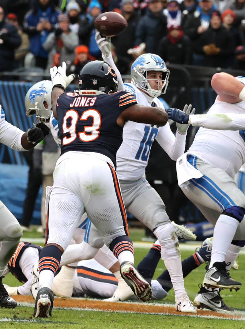 Detroit Lions quarterback Jared Goff gets off a pass just ahead of the pressure of Chicago Bears defensive tackle Justin Jones during their game Sunday, Dec. 10, 2023 at Soldier Field in Chicago.