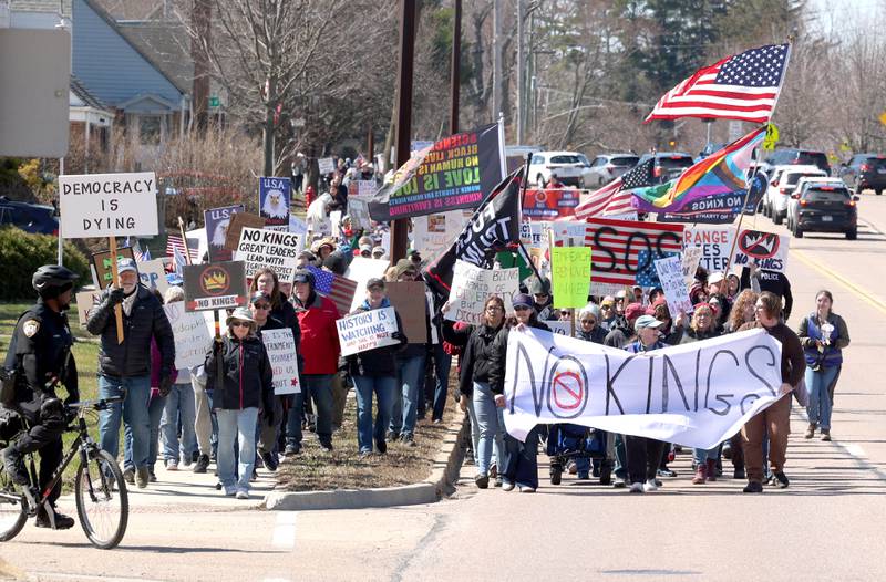Protesters march north Saturday, March 28, 2026, on Sycamore Road in DeKalb during a No Kings march and rally against the federal actions of President Donald Trump and his administration.