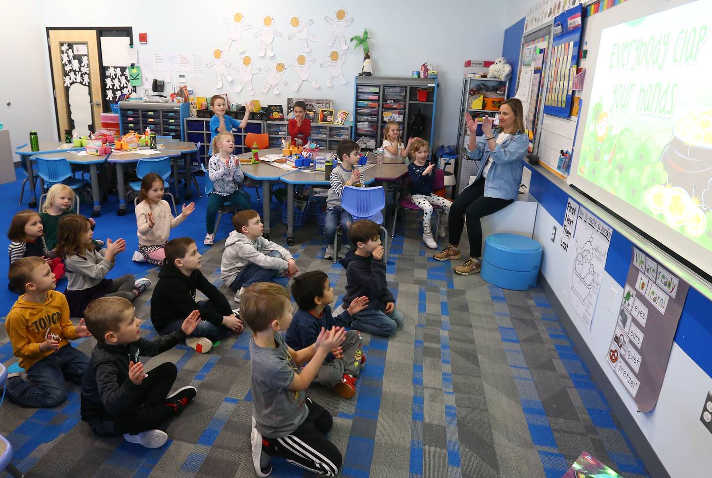 Mrs. Karin Kummer, a kindergartener teacher at Waltham School, teaches her students letters and numbers in a song while using the Smartboard on Tuesday, March 8, 2022 in Utica.