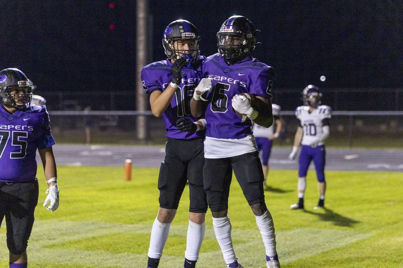 Plano's Waleed Johnson (6) is congratulated by teammate Noah Uhrich after a touchdown during Friday's game at Plano.