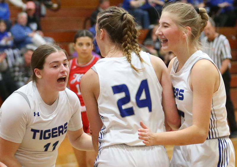Princeton's Makayla Hecht, Keighley Davis and Payton Brandt react after Davis made a shot against Hall during the Princeton Holiday Girls Basketball Tournament on Friday, Nov. 23, 2024 at Princeton High School.